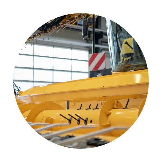 Part of a yellow combine harvester